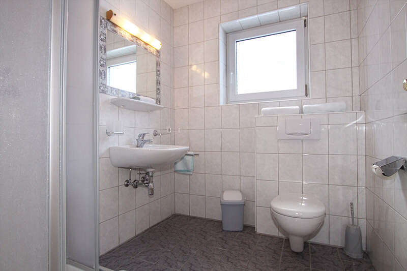 Badezimmer mit Wc und Dusche in der Ferienwohnung 1